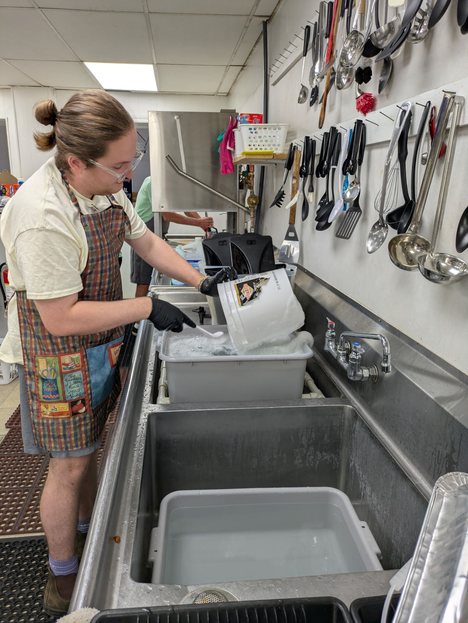 Christopher Wier doing dish work at a community food service